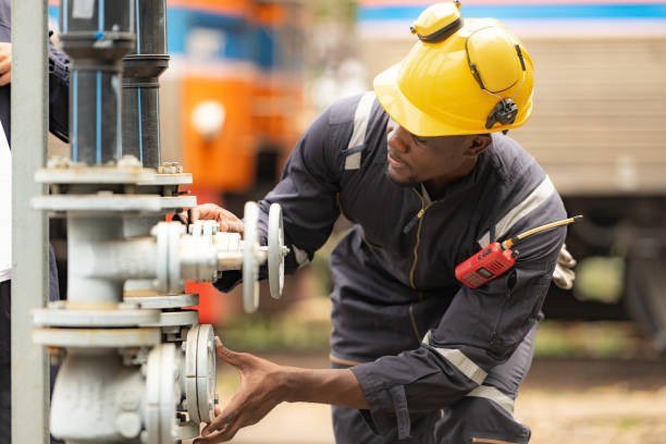 Technician inspecting a valve and process piping